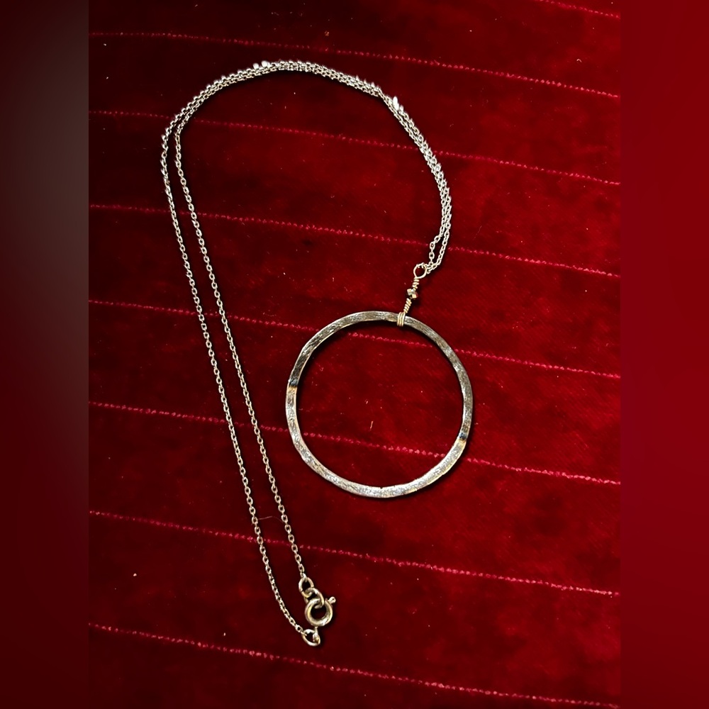 Silver necklace with oxidized pendant.